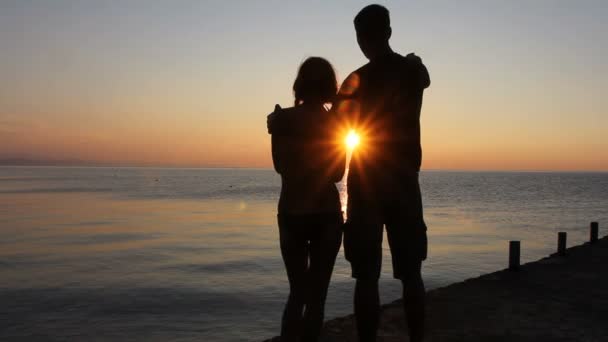 Silhouette de couple à la plage. Lumière du coucher du soleil . — Video