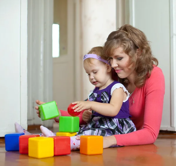 Mother and baby plays with toys — Stock Photo, Image