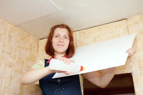 Woman glues ceiling tile at home — Stock Photo, Image