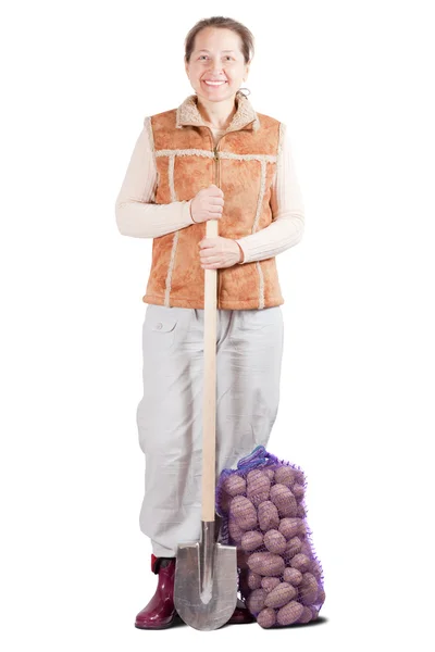 Farmer with harvested potatoes and spade — Stock Photo, Image