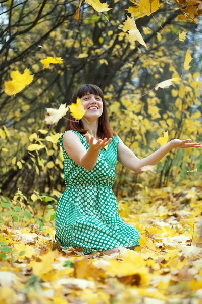 Girl throwing maple leaves — Stock Photo, Image