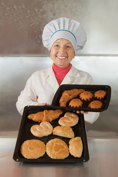 Panettiere con pasticcini in panetteria — Foto Stock