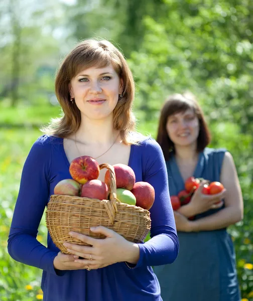 Happy women with apples in garden — Stock Photo, Image