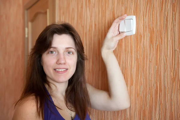 Woman with light-switch — Stock Photo, Image