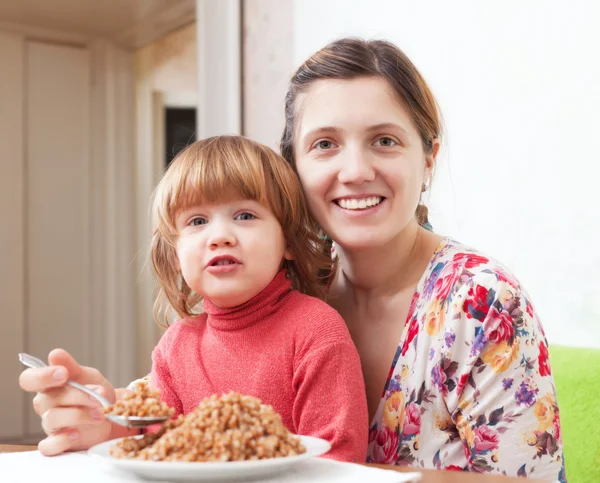 Family eats buckwheat — Stock Photo, Image