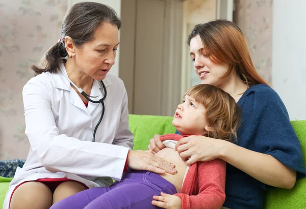 Médico pediatra amigável examinando bebê — Fotografia de Stock