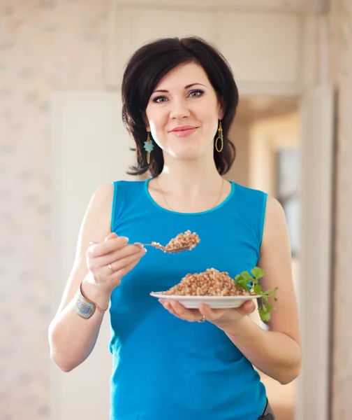 Woman with buckwheat porridge — Stock Photo, Image