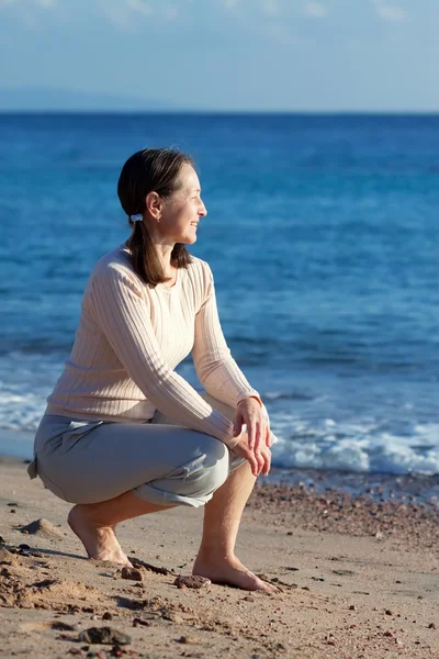 Glad mogen kvinna på strand — Stockfoto