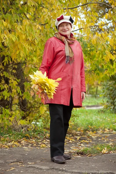 Mature woman with maple posy — Stock Photo, Image