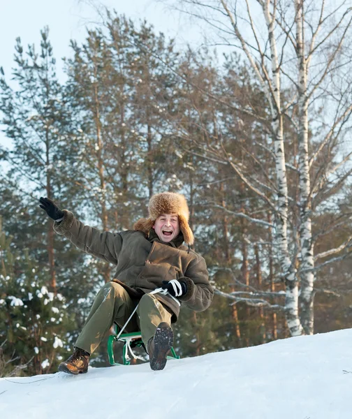 Man sliding on sleds downhill — Stock Photo, Image