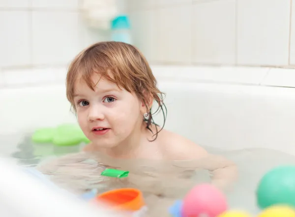 Happy kid bathes in bath — Stockfoto