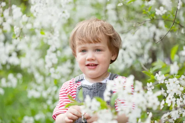 Baby girl in spring garden — Stock Photo, Image