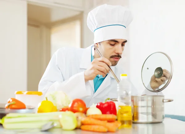 Cook man tasting soup — Stock Photo, Image