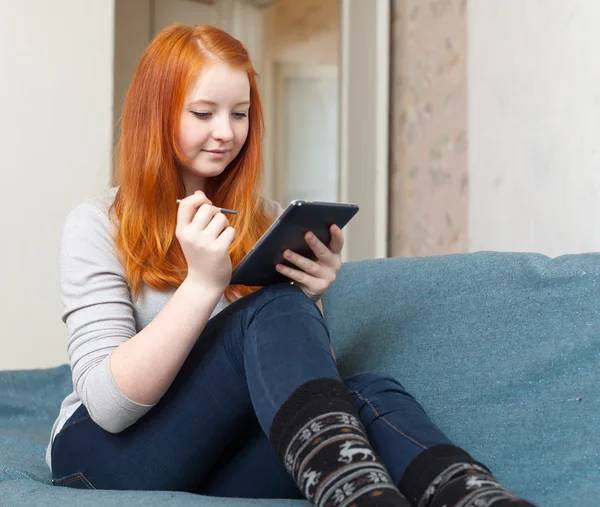 Teenager uses tablet computer or e-book — Stock Photo, Image