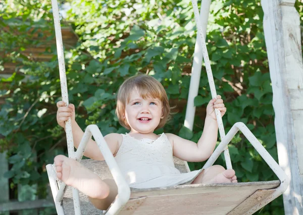 Laughing child on swing — Stock Photo, Image