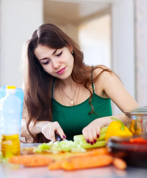 Woman cutting green celery — Stock Photo, Image