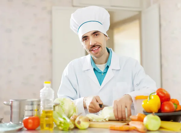 Handsome cook cooking in kitchen — Stock Photo, Image