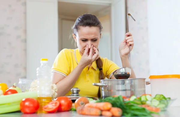 Femme tenant son nez à cause de la mauvaise odeur de la soupe — Photo