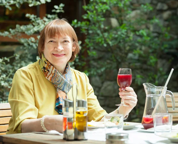 Mature woman with glass of red wine — Stock Photo, Image