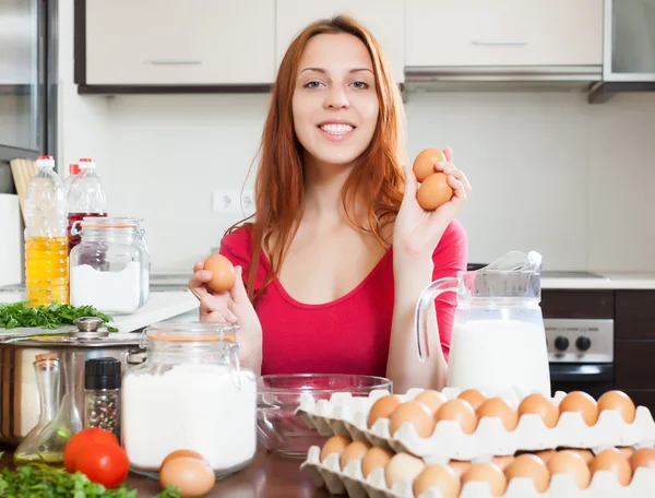 Cheeful woman in red with eggs — Stock Photo, Image