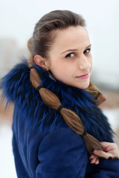 Woman in blue coat at wintry park — Stock Photo, Image