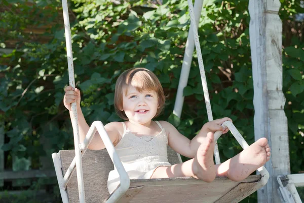 Laughing girl on swing — Stock Photo, Image