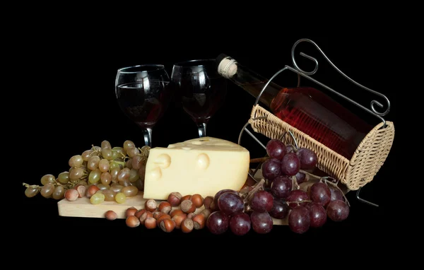 Wine bottle with grapes and cheese — Stock Photo, Image