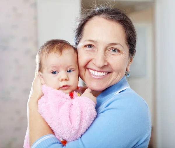 Happy mature woman with little baby — Stock Photo, Image