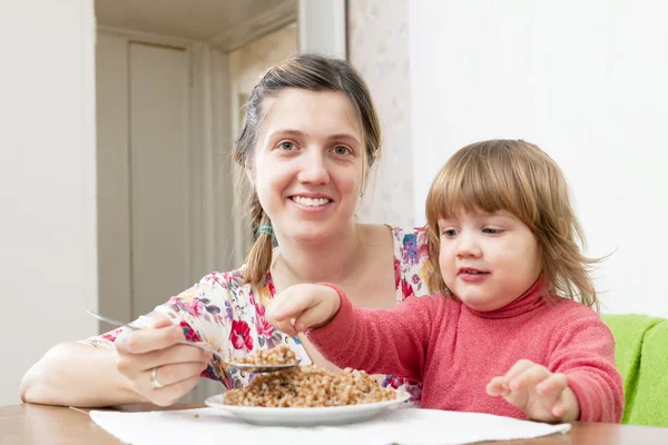 Happy mother feeding her 2 years child — Stock Photo, Image