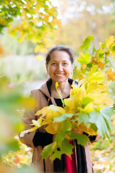 Mature woman in autumn — Stock Photo, Image