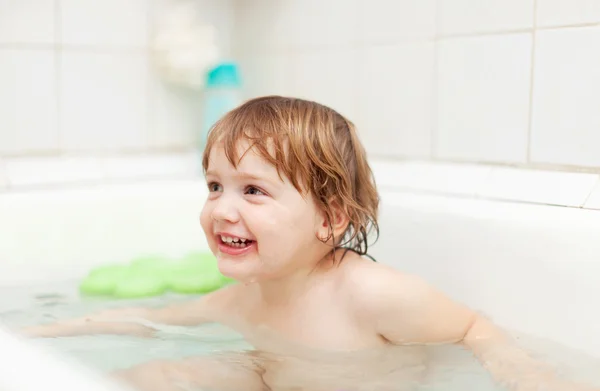 Happy child bathes in bathtub — Stock Photo, Image