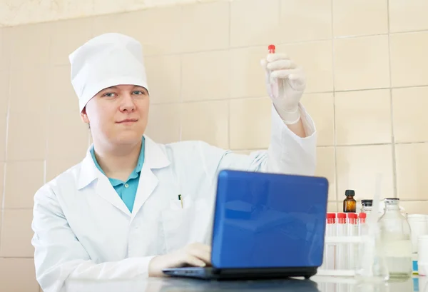 Scientist with test tubes — Stock Photo, Image