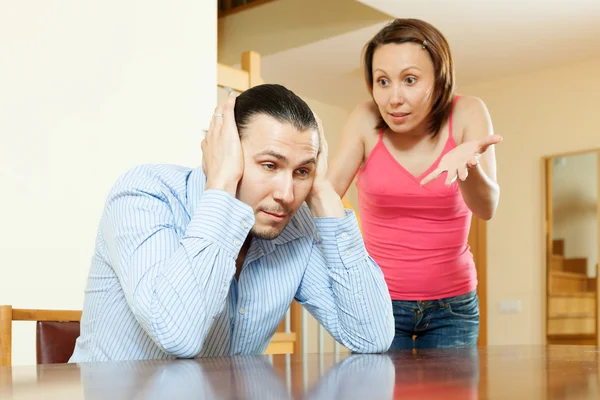 Family quarrel. Tired man listening to his angry wife — Stock Photo, Image