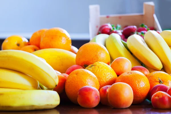 Heap of ripe fruits on kitchen — Stock Photo, Image