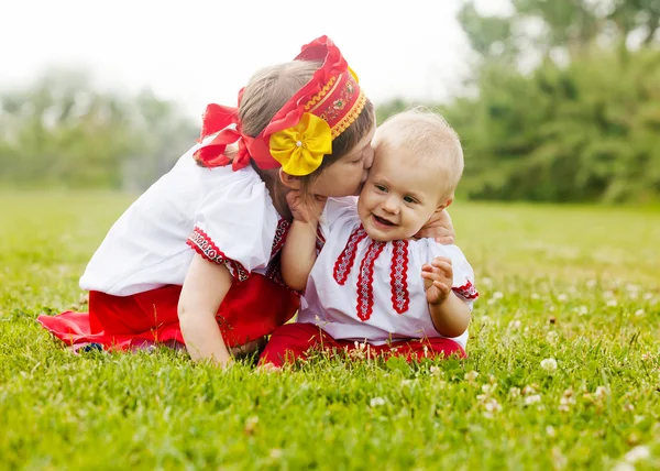 Two happy children in folk clothes in summer — Stock Photo, Image