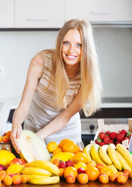 Счастливая женщина с дыней и другими фруктами — стоковое фото