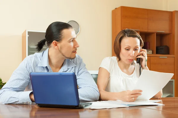 Man and woman with financial document — Stock Photo, Image