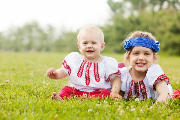 Children in russian folk clothes on grass — Stock Photo, Image