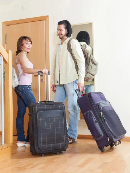 Happy couple together with luggage leaving — Stock Photo, Image