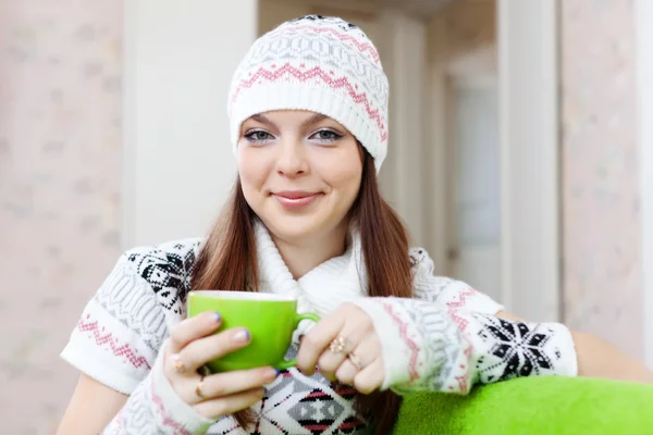 Girl warms with cup of at house — Stock Photo, Image