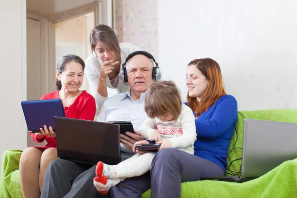 Happy family enjoys with few various laptops — Stock Photo, Image