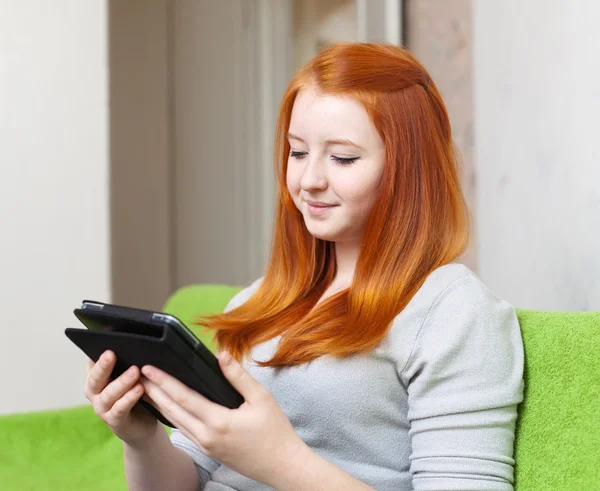 Teenager girl reads e-book — Stock Photo, Image