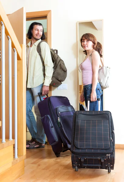 Couple with suitcases near door at home — Stock Photo, Image