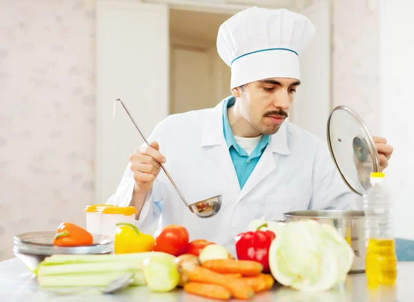 Cook man works at kitchen — Stock Photo, Image