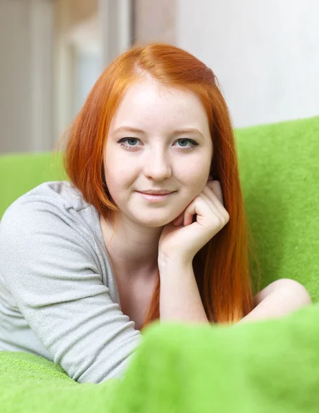 Red haired young girl relaxing on couch — Stock Photo, Image