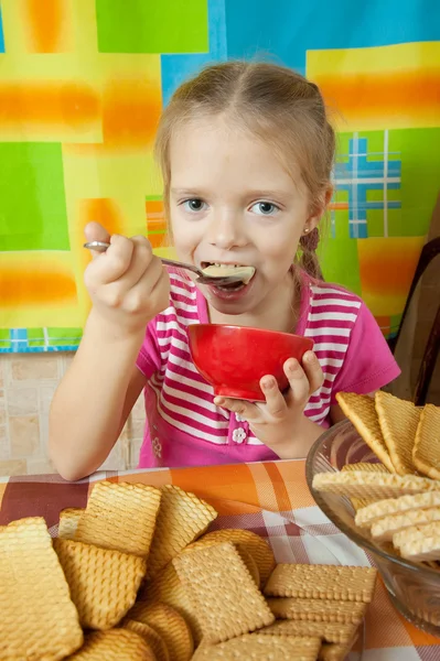 Menina comendo sobremesa de leite — Fotografia de Stock