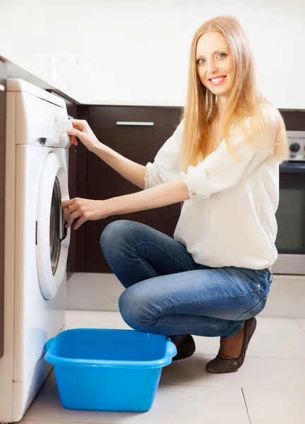 Cheerful long-haired woman doing laundry — Stock Photo, Image