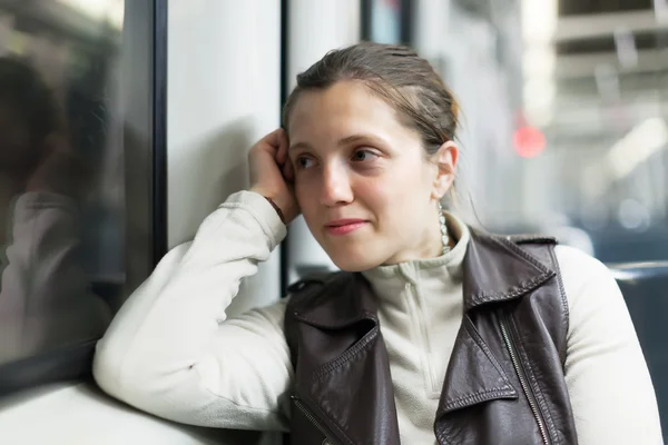 Dreaming woman in subway train — Stock Photo, Image