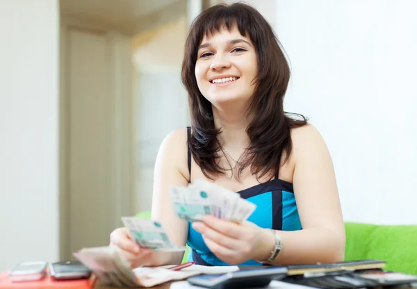 Happy girl calculates the family budget — Stock Photo, Image