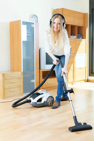 Happy long-haired woman with vacuum cleaner — Stock Photo, Image